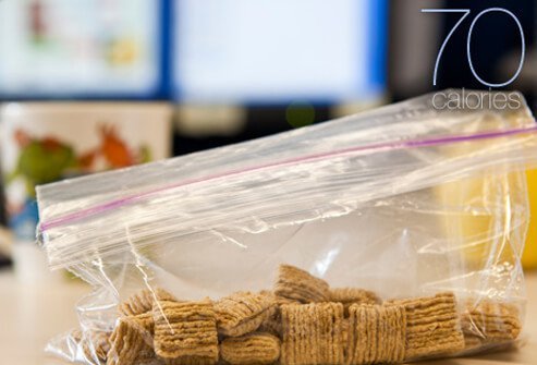 A sandwich bag filled with dry oat square cereal.