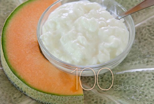 A slice of cantaloupe with cottage cheese.