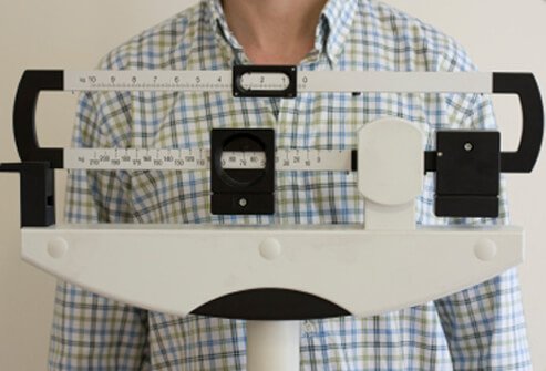 A man weighs himself.