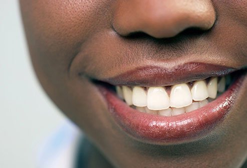 The simple act of smiling may help you feel more positive. 