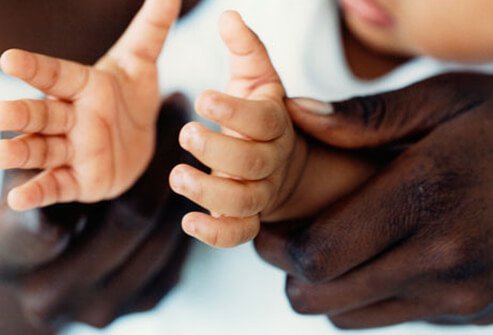 A father clapping his baby's hands.