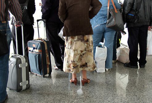 People waiting to check their luggage.