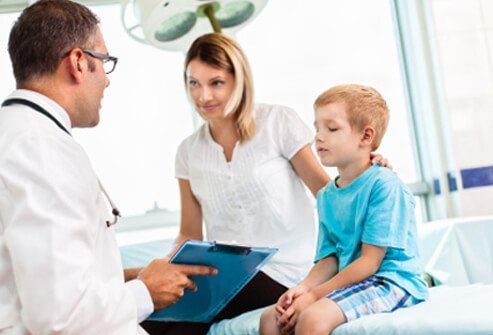 A mother discusses her child's condition with a doctor.