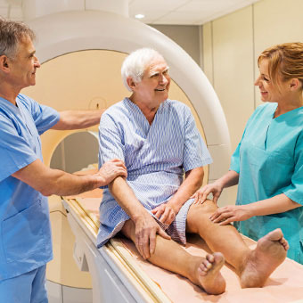 An elderly male patient prepares for an MRI scan.