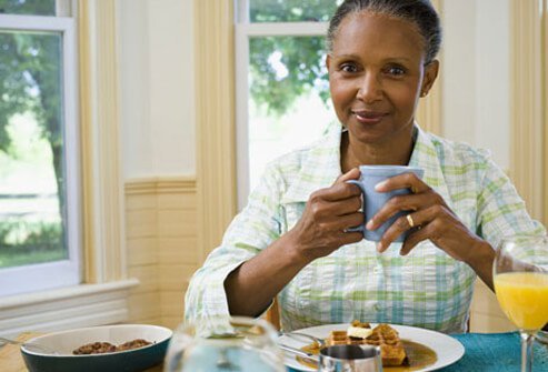 A woman eating breakfast.