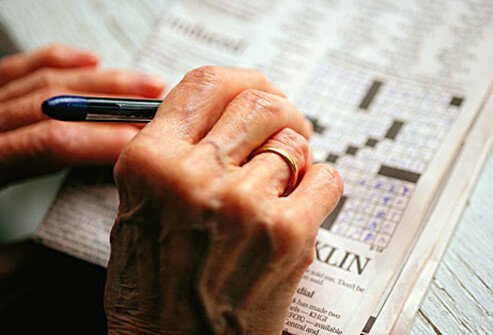 A woman with dementia doing a crossword puzzle.