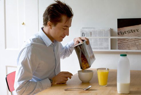 A man eating cereal, high in vitamin D, for breakfast.