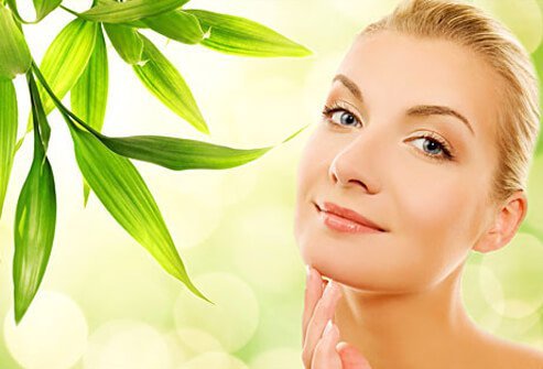 Photo of a woman surrounded by plants.