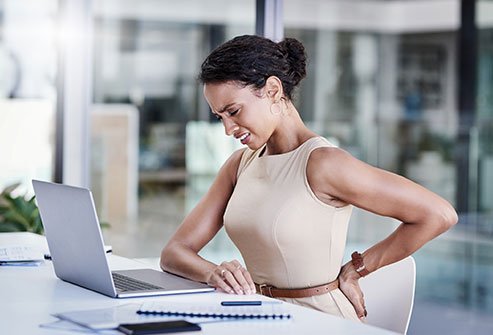 Does sitting all day at work cause back pain?