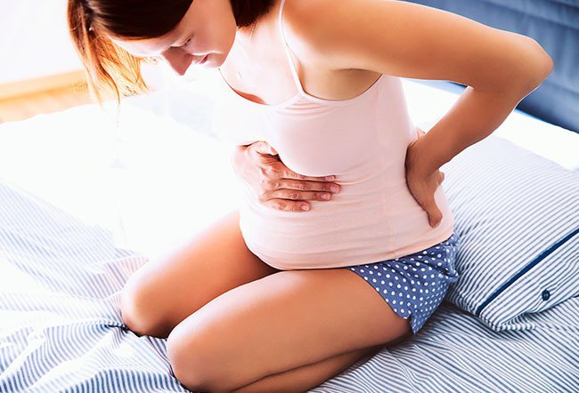 Braxton-Hicks contractions are usually painless contractions that begin in the first trimester of pregnancy. Unlike Braxton-Hicks, real contractions occur at regular intervals and become stronger and longer over time. The pain and discomfort of real contractions isn't relieved by a change in position.