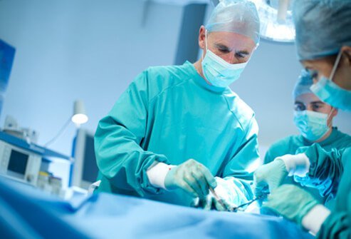 A doctor performs surgery to treat cancer. 