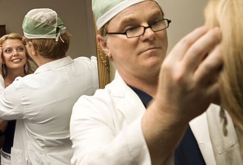 A surgeon consulting with a cosmetic surgery patient.