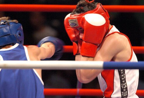 Boxers throwing punches during a boxing match, one of the causes of dementia pugilistica. 