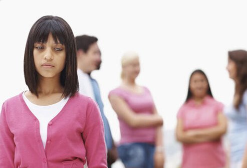 Photo of an isolated and depressed teenage girl.