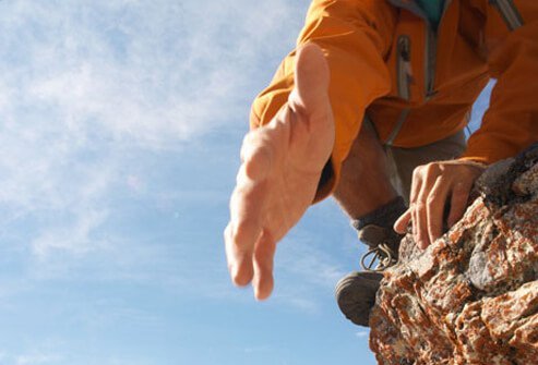 Photo of a climber reaching out for help.