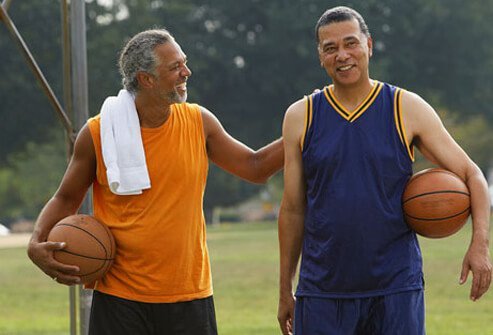 A couple guys playing basketball.