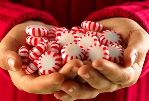 A photo of hands with peppermints.