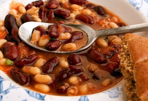 A photo of bean soup with bread.