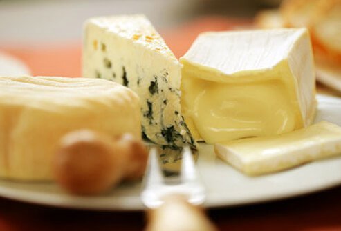A photo of cheese slices and a fork.