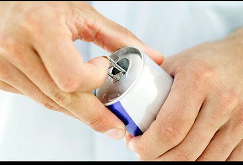 A man opening an energy drink can.