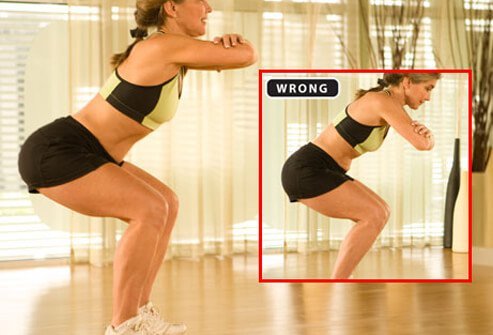 A trainer demonstrating the proper form for squats.