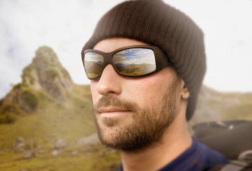 Photo of man wearing reflective sunglasses.