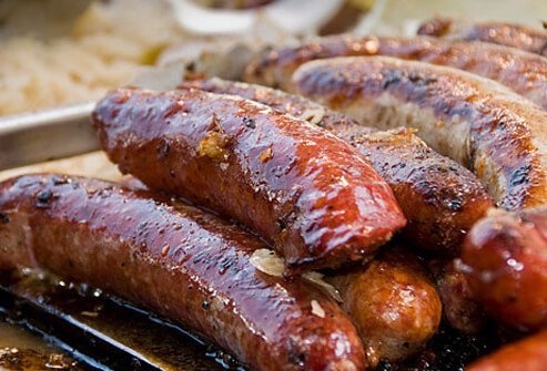 Sausages being cooked on a grill.