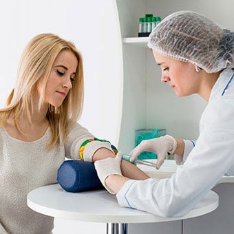 A woman gets her blood drawn.