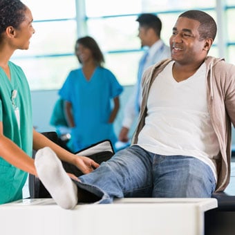 A man with a foot injury seeks medical attention at a hospital.