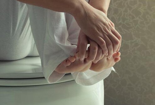 Photo of woman touching toes.
