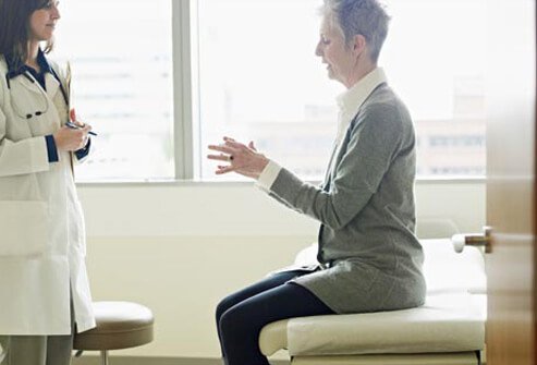 Photo of woman talking to doctor.
