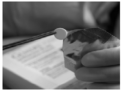 To remove the GLIADEL Wafer, gently
grasp the wafer with the aid of forceps and place it onto a designated sterile
field - Illustration To remove the GLIADEL Wafer, gently
grasp the wafer with the aid of forceps and place it onto a designated sterile
field - Illustration