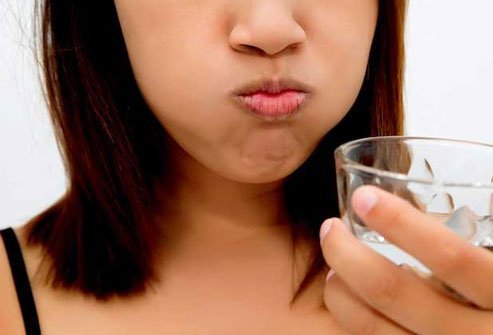 Swish a teaspoon of baking soda in a half glass of water and rinse your mouth.