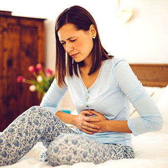 A woman experiences abdominal discomfort.