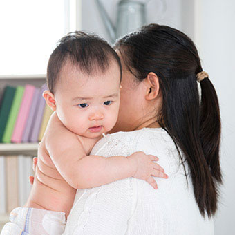 A mom comforts her baby with hiccups.