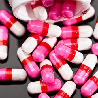 A close-up of antihistamine pills that can used to treat hives.