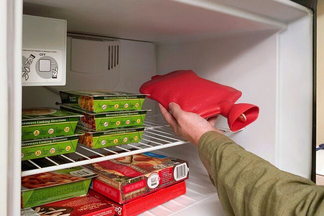 Fill a hot water bottle and put it in the freezer to keep you cool. 