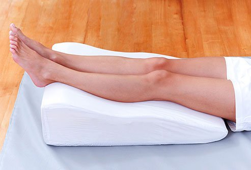 Putting a pillow or rolled-up towel under your knees can help keep the natural curve of your spine.