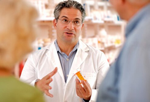 A pharmacist discussing medications with a couple.