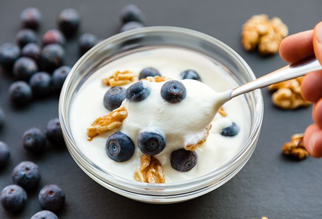 The United States Department of Agriculture (USDA) recommends three cup equivalents of dairy per day (including yogurt, cream cheese, low-fat milk) for those older than nine years of age. So, if people stay within recommended limits, yogurt will help keep them healthy. 