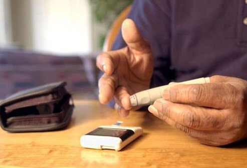 A man performing a blood glucose test, diabetes can cause low testosterone.