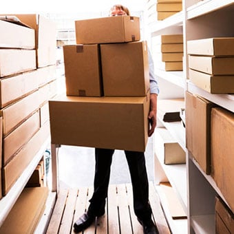 Proper technique for safely lifting a box to reduce the risk of back injury.