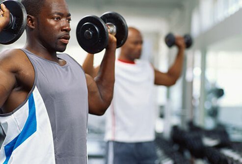 A man lifts weights in the gym.