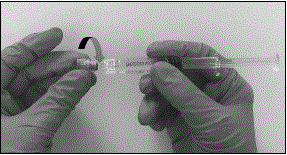 Connect the syringe to the vial adapter by screwing it clockwise into the opening on the side of the vial adapter - Illustration
