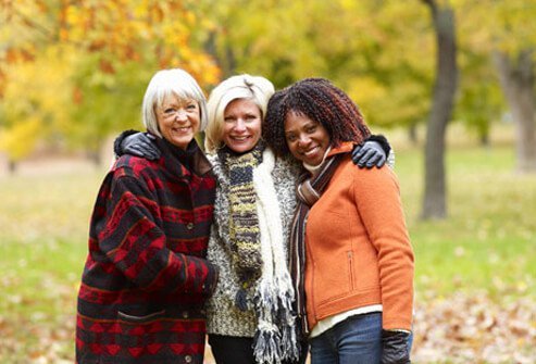 A group of three mature women, experiencing menopause.