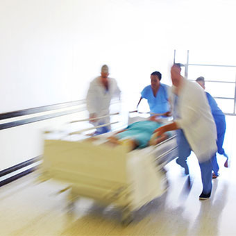 A group of doctors rush to help a sick patient.