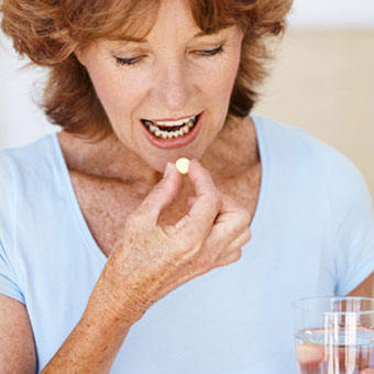 A woman takes her vitamin.