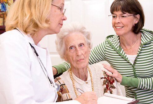 A doctor discusses osteoporosis with a senior woman and her daughter.