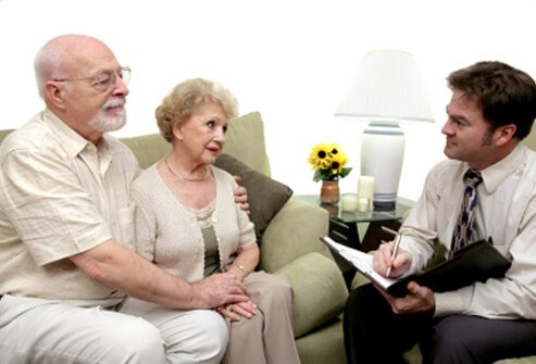 A counselor meets with an elderly couple to discuss pancreatic cancer concerns.