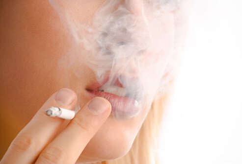 A woman smoking a cigarette.